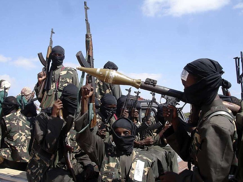 FILE - Armed al-Shabab fighters ride on pickup trucks as they prepare to travel into the city, just outside the capital Mogadishu, in Somalia on Dec. 8, 2008. The al-Qaida-linked militant group al-Shabab claimed an attack that killed three Emirati troops and a Bahraini military officer on a training mission at a military base in the Somali capital, authorities said Sunday, Feb. 11, 2024.(AP Photo/Farah Abdi Warsameh, File)