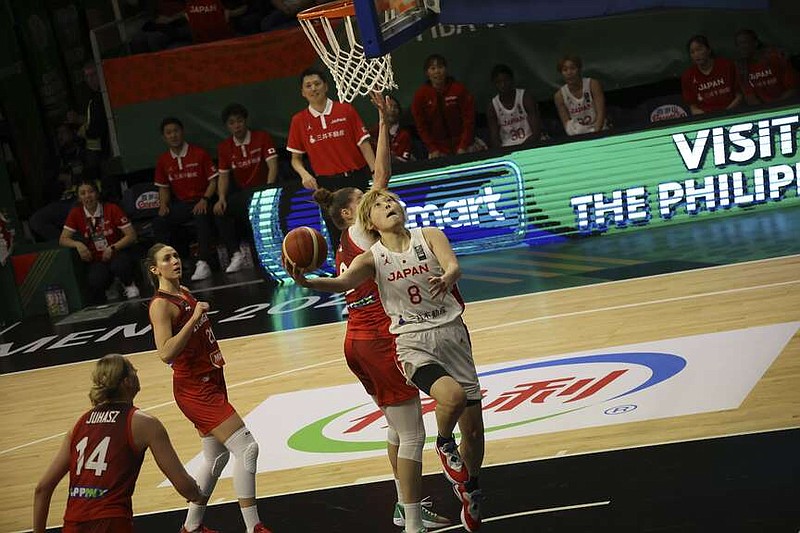 Maki Takada of Japan goes to the basket during the women's basketball Olympic qualifying tournament second round match between Japan and Hungary in Sopron, Hungary, Friday, Feb. 9, 2024. (Zsombor Toth/MTI via AP)