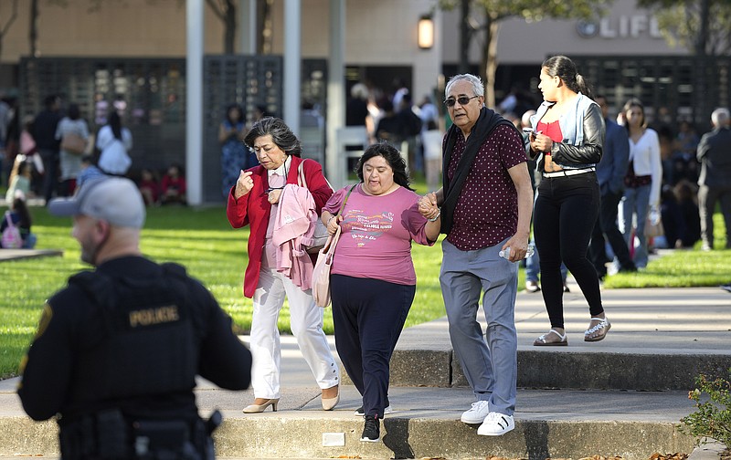 Houston Police officers watch over displaced churchgoers outside Lakewood Church, Sunday, Feb. 11, 2024, in Houston, after a reported shooting during a Spanish church service. (Karen Warren/Houston Chronicle via AP)