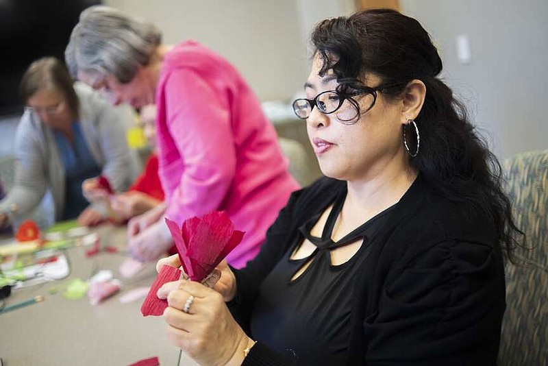 Rosie Kurakuma makes a paper flower Thursday during a meeting of the English Conversation Group at the Rogers Public Library. The group members practice English through conversation and by doing activities. Visit nwaonline.com/photos for today's photo gallery.

(NWA Democrat-Gazette/Charlie Kaijo)