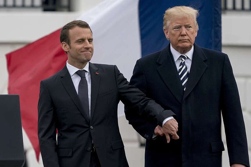 FILE – Then-U.S. President Donald Trump and French President Emmanuel Macron hold hands during a ceremony at the White House in Washington, Tuesday, April 24, 2018. As chances rise of a Joe Biden-Trump rematch in the U.S. presidential election race, America's allies are bracing for a bumpy ride, with concerns rising that the U.S. could grow less dependable regardless of who wins. (AP Photo/Andrew Harnik, File)