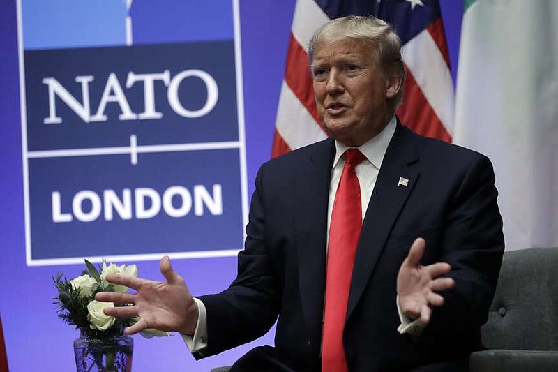 FILE - President Donald Trump meets with Italian Prime Minister Giuseppe Conte during the NATO summit at The Grove, Wednesday, Dec. 4, 2019, in Watford, England.  Former US president Donald Trump says he once warned that he would allow Russia to do whatever it wants to NATO member nations that are “delinquent” in devoting 2% of their gross domestic product to defense. Trump's comment on Saturday represented the latest instance in which the former president and Republican front-runner seemed to side with an authoritarian state over America's democratic allies. (AP Photo/ Evan Vucci, File)