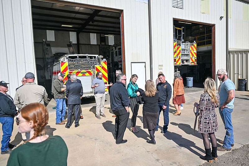Attendees mingle Tuesday outside at the ribbon cutting for the Fire Department Maintenance Center in Fort Smith. The new facility will greatly enhance the Fire Departmentâ€™s ability to repair and maintain its vehicles. The previous facility had only one maintenance bay and forced mechanics to work outside when multiple vehicles were in the shop. The multiple bays at the new facility will help protect mechanics from the elements as well as expedite repairs and maintenance. Visit rivervalleydemocratgazette.com/photo for today's photo gallery. (River Valley Democrat Gazette/Caleb Grieger)