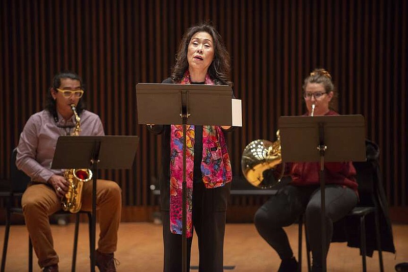 Moon-Sook Park sings soprano during a rehearsal at the Faulkner Performing Arts Center at the University of Arkansas in Fayetteville. Accompanying her is Katey Halbert on horn, Sarah Hetrick, on saxophone (left). The three faculty members are part of the committee bringing the sixth annual SHE Festival of Women in Music to the university campus March 1-3. 
(NWA Democrat-Gazette/J.T. Wampler)