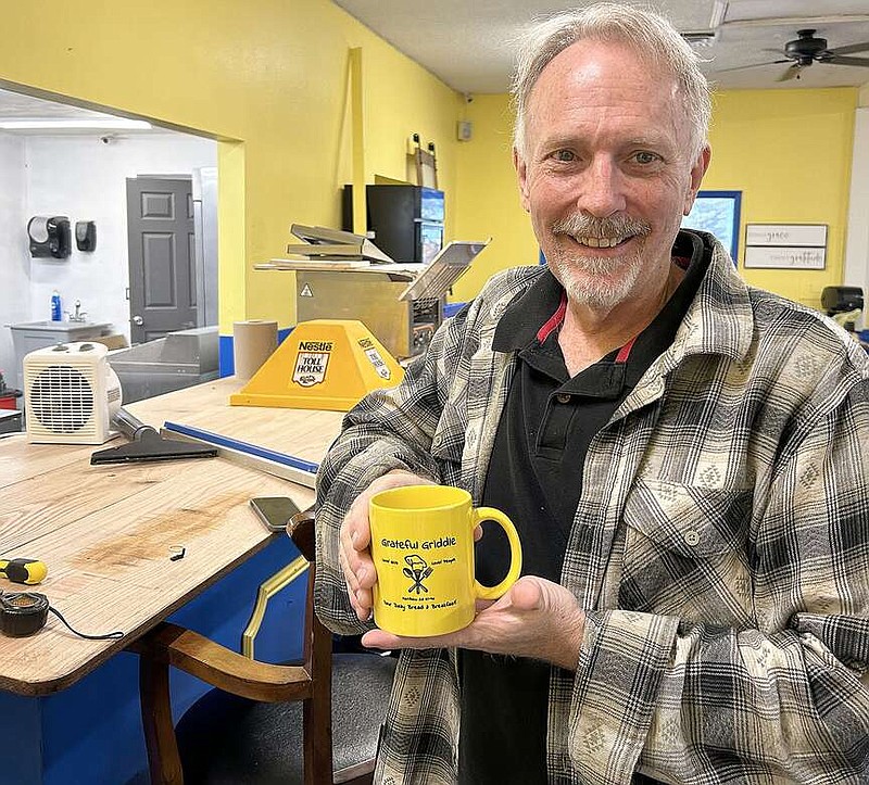 Annette Beard/Pea Ridge TIMES
Kirk Pearson is working hard preparing for the opening of the Grateful Griddle in Pea Ridge. The building has been completely renovated and new furniture has been installed. Bright yellow coffee mugs display the Grateful Griddle name.