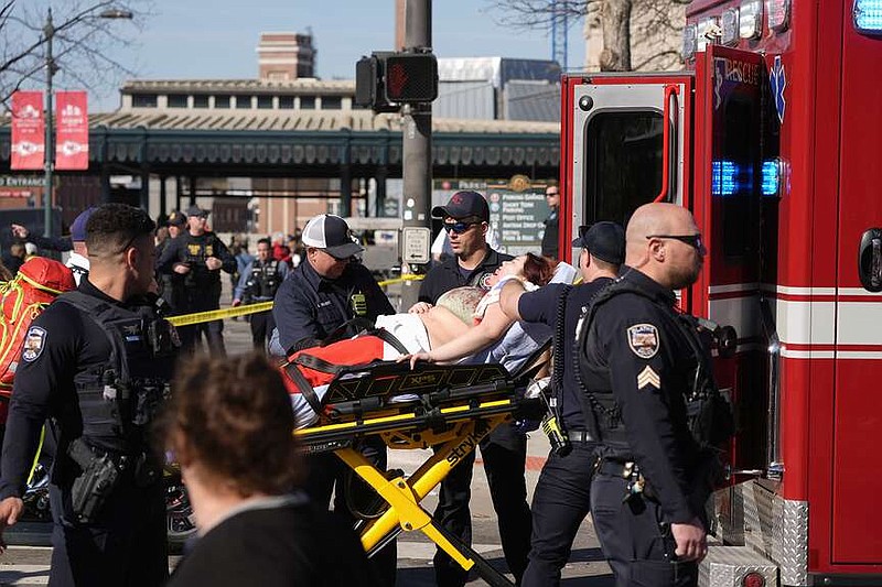 A person is taken to an ambulance after an incident following the Kansas City Chiefs victory parade in Kansas City, Mo., Wednesday, Feb. 14, 2024. The Chiefs defeated the San Francisco 49ers Sunday in the NFL Super Bowl 58 football game. (AP Photo/Charlie Riedel)