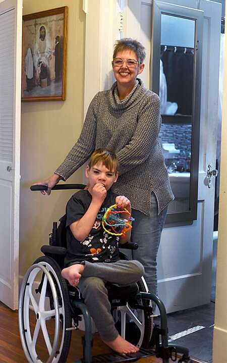 Cleo Norman/News Tribune
Julia Atkin and her 7-year-old son, Scott, are pictured in their home on Clark Avenue. Atkin applied for a federal grant a few months ago that would fund a home renovation project and enlarge her bathroom.