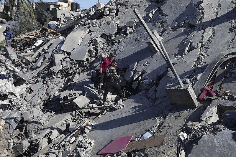 Palestinians search for survivors after an Israeli airstrike on building of Rayan family in Nusseirat refugee camp, central Gaza Strip, Thursday, Feb. 15, 2024. (AP Photo/Adel Hana)