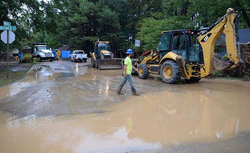 Fayetteville Water and Sewer Operations staff work on Sept. 21, 2021, to repair a 36-inch water transmission line that ruptured beneath Makeig Court. The City Council may authorize compensation of up to $100,000 to property owners who have homes or businesses damaged in water or sewer line breaks.

(File photo/NWA Democrat-Gazette/Andy Shupe)