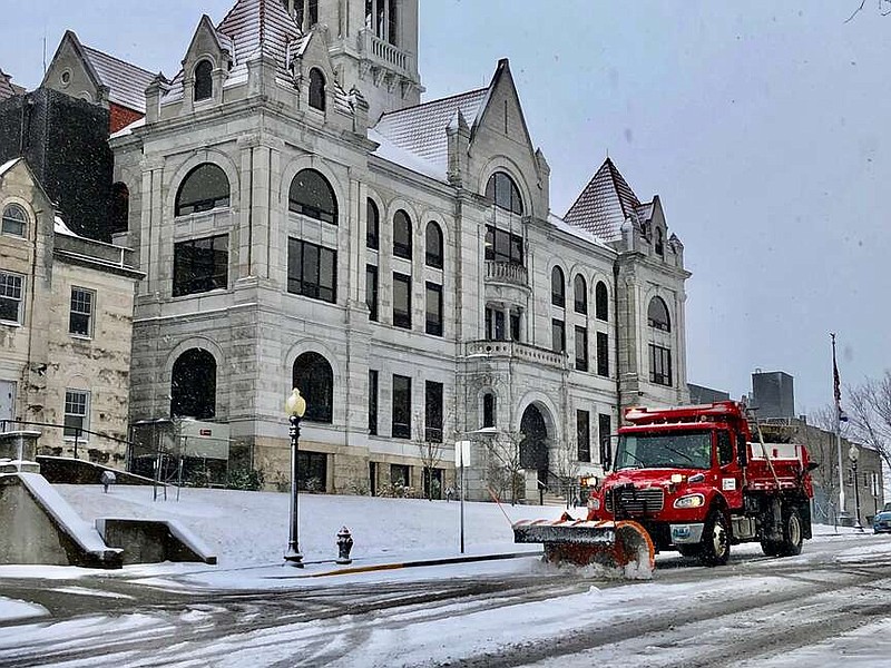 Joe Gamm/News Tribune
A Jefferson City street crew plows snow off Monroe Street around noon Friday. The Capital City received about a tenth of an inch of rain before snow began to fall mid-morning.