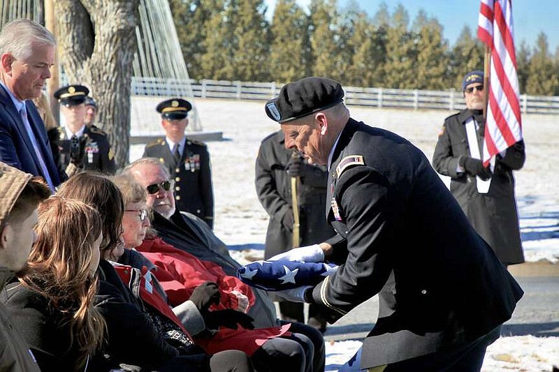 Alexa Pfeiffer/News Tribune photo: 
Chief Warrant Officer Isom Folsom of the Missouri National Guard presents a folded flag to the family of Wilburn C. Rowden during his funeral Saturday, Feb. 17, 2024, at Hawthorne Memorial Gardens in Jefferson City.