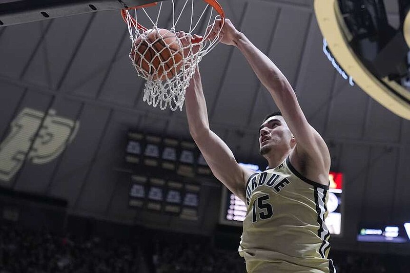 Purdue center Zach Edey (15) gets a basket on a dunk against Minnesota during the second half of an NCAA college basketball game in West Lafayette, Ind., Thursday, Feb. 15, 2024. (AP Photo/Michael Conroy)