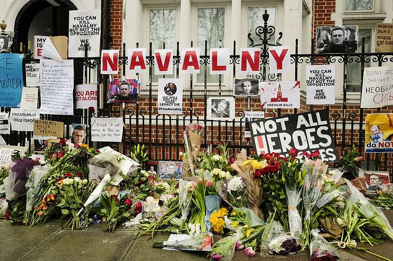 Flowers and tributes are left opposite the Russian embassy, to commemorate the death of Alexei Navalny in London, Saturday, Feb. 17, 2024. Navalny, who crusaded against Russian corruption and staged massive anti-Kremlin protests as President Vladimir Putin's fiercest foe, died Friday in the Arctic penal colony where he was serving a 19-year sentence, Russia's prison agency said. He was 47.(AP Photo/Alberto Pezzali)