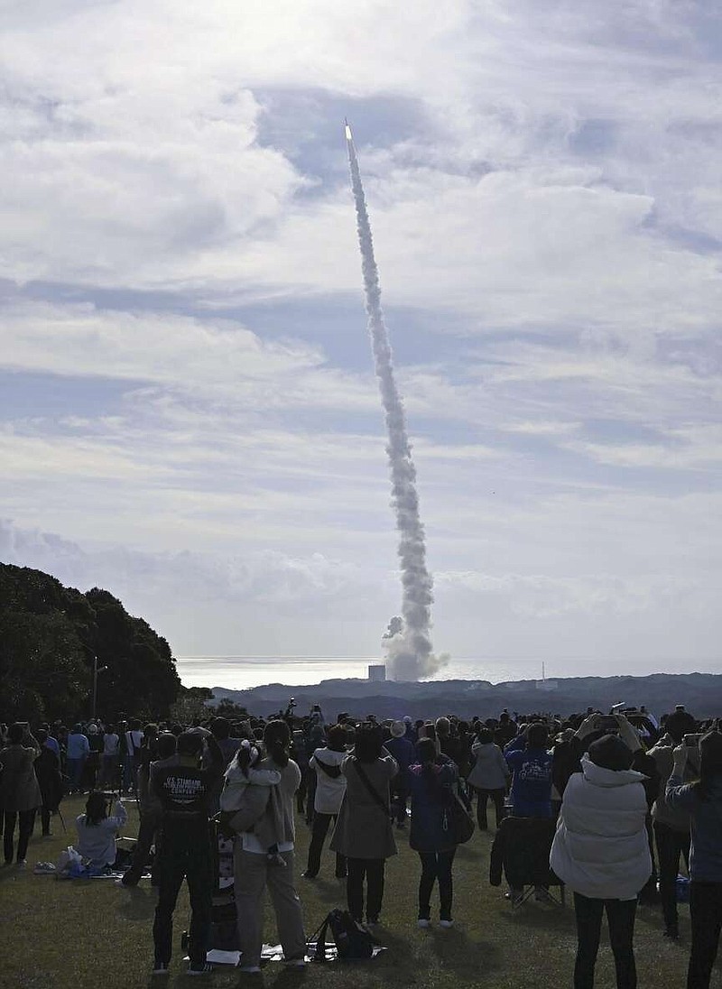 People in Minamitane town, Kagoshima, southern Japan, watch as an H3 rocket lifts off from Tanegashima Space Center Saturday, Feb. 17, 2024. (Kyodo News via AP)