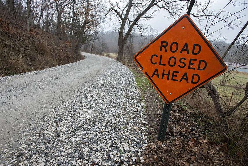 A sign warns drivers of a closed road Friday in Washington County. The Washington County Road Department is planning to pave 200 miles of county roads in 2024. Visit nwaonline.com/photo for today's photo gallery.
(NWA Democrat-Gazette/J.T. Wampler)