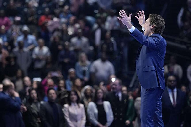 Pastor Joel Osteen preaches during a service at Lakewood Church Sunday, Feb. 18, 2024, in Houston. Pastor Osteen on Sunday welcomed worshippers back to Lakewood Church for the first time since a woman with an AR-style opened fire in between services at his Texas megachurch last Sunday. (AP Photo/David J. Phillip)