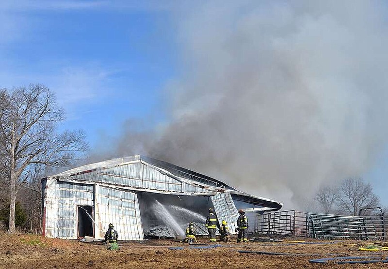 Annette Beard/Pea Ridge TIMES
The barn of Robert Foster, Pea Ridge, burned Monday morning. In addition to the loss of the barn, Foster said there was a tractor, discbine, hay baler and about 45 bales of hay in the barn. Firefighters from Bella Vista and Little Flock assisted Pea Ridge Fire-EMS firefighters trying to extinguish the fire. For more photographs, go to the PRT gallery at https://tnebc.nwaonline.com/photos/.