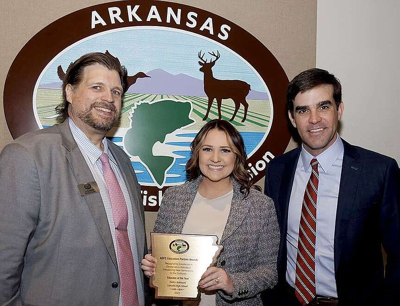 Submitted photo
JJ Gladden, (left) assistant chief of education with Arkansas Game and Fish Commission, and Austin Booth, commission director, present Lincoln High School teacher Hailey Robinson with the 2023 Conservation Educator of the Year award during the commission's Feb. 15 meeting in Little Rock.