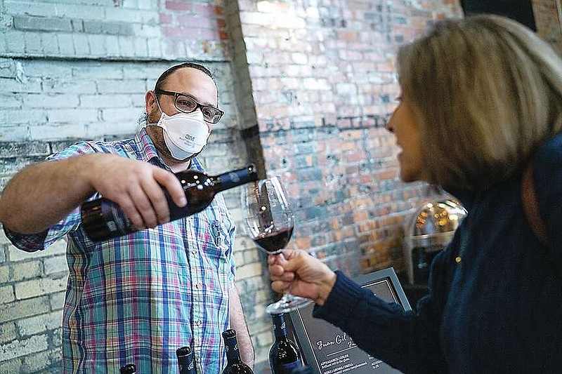 News Tribune file photo: 
Paul Farnam pours Lisa Clark a glass of wine during the inaugural Whiskey, Wine and Welcome Home event held April 7, 2022, at the Millbottom in Jefferson City.
