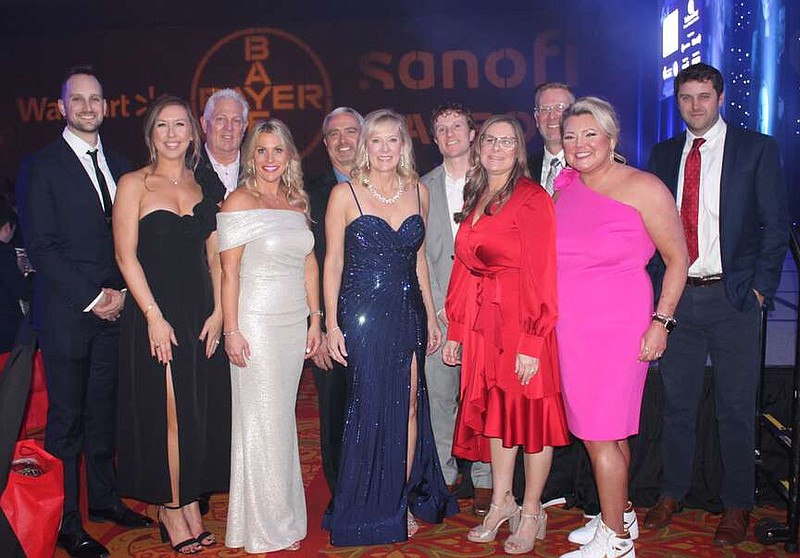 Kyle and Mille Alderman (from left); Rick Dungan and Kelley Padgett; Mike and Sheila Gamble, Heart Ball co-chair; Mark Hamrick; Andrea and Mike Cunningham and Meg Zapata; and Paul Conceison help represent Sonofi in support of the American Heart Association at the Heart Ball. 
(NWA Democrat-Gazette/Carin Schoppmeyer)