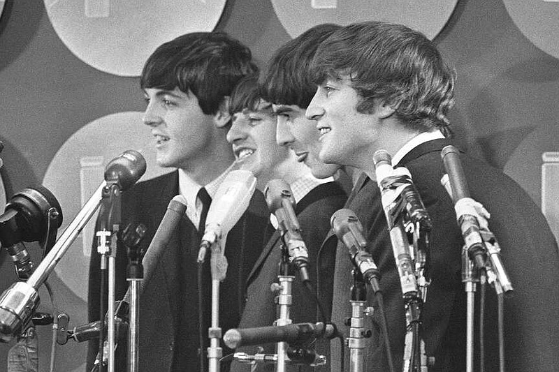 ARCHIVO - The Beatles hablan con medios de comunicación en el Aeropuerto Internacional Kennedy a su llegada el 7 de febrero de 1964 en Nueva York. Los Beatles tendrán cada uno una película biográfica que pondrá a los Fabulosos Cuatro en el centro de atención bajo la dirección de Sam Mendes. (Foto AP, archivo)