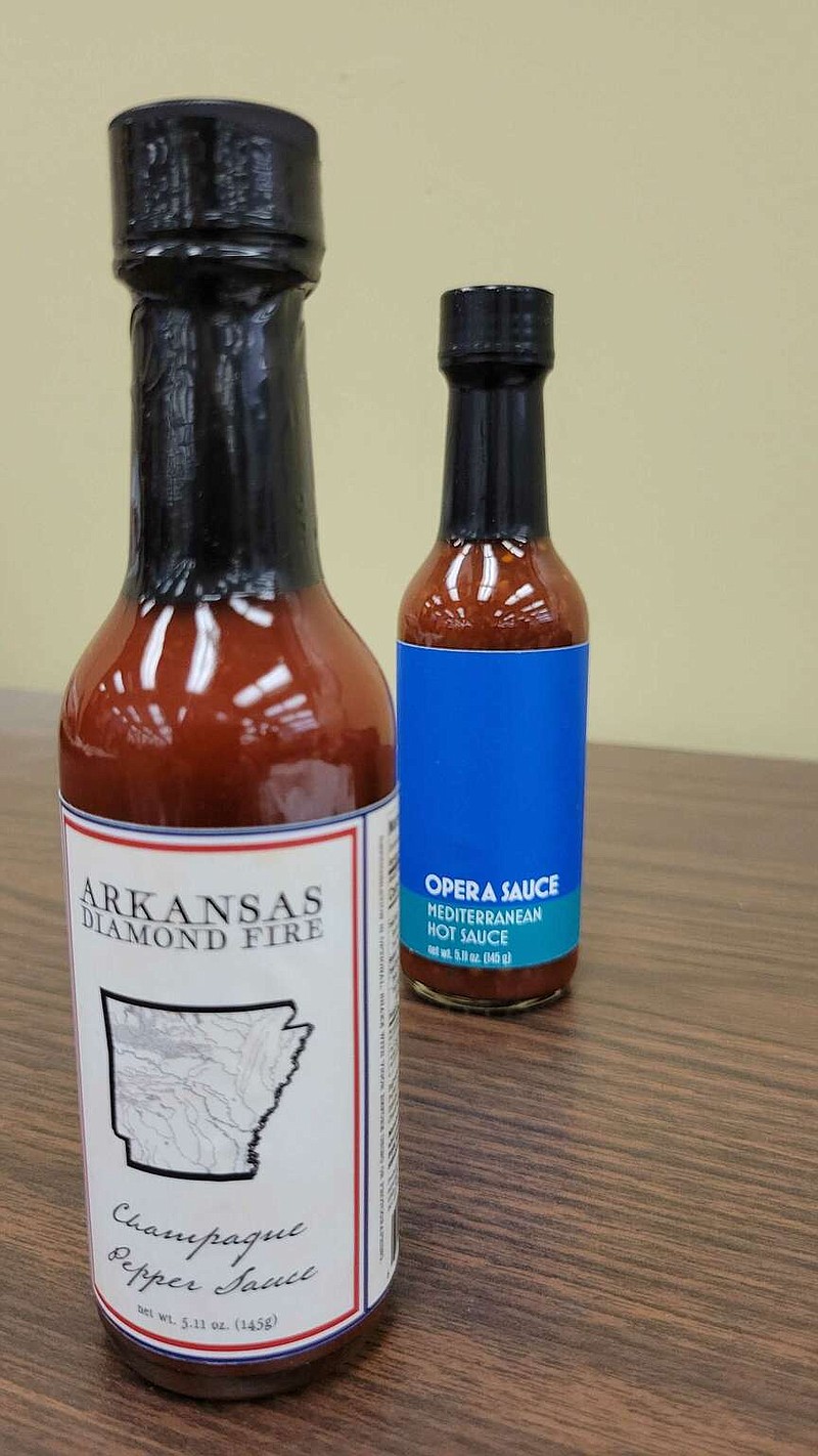 The two products made by Supertasterz, Arkansas Diamond Fire and Opera Sauce, are sold in small bottles, for souvenirs or gifts. (The Sentinel-Record/Lance Brownfield)