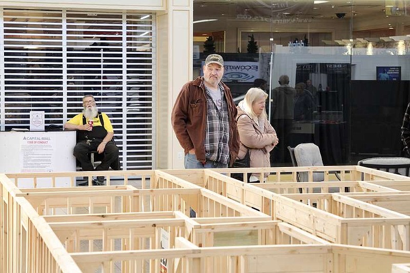 Alexa Pfeiffer/News Tribune photo: 
Marty Rush admires a scale home frame built by the students at Nichols Career Center that was on display Saturday, Feb. 24, 2024, at the annual Home Builders Association Home Show at Capital Mall in Jefferson City.