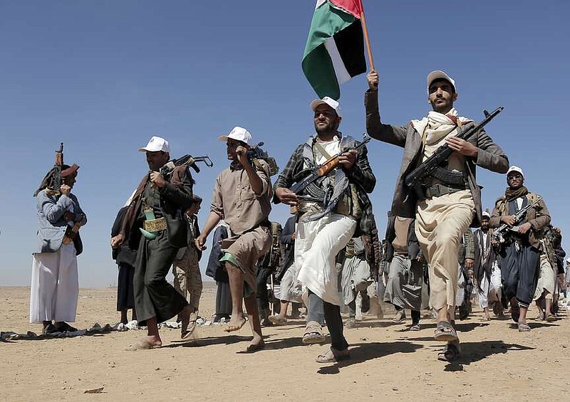 FILE - Houthi fighters march during a rally of support for the Palestinians in the Gaza Strip and against the U.S. strikes on Yemen outside Sanaa on Jan. 22, 2024. The U.S. and Britain have struck more than a dozen Houthi targets in Yemen. The strikes on Saturday, Feb. 24, answer a recent surge in attacks by the Iran-backed militia group on ships in the Red Sea and Gulf of Aden. (AP Photo, File)