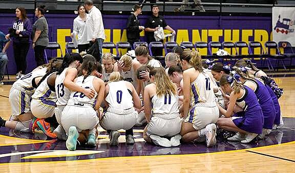 The unbeaten Fouke girls basketball team and the school varsity cheerleaders pray at midcourt after each game. (Submitted photo courtesy of Fouke athletics)