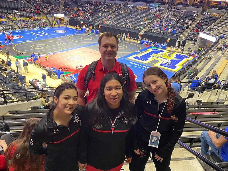 Photo submitted by Ellysia Wasson Coach Reid Davis, Anjelika Alarcon, Gisel Aragon and Elly Wasson pose for a photo at the state wrestling tournament in Columbia. Wasson said the tournament was "unlike any other" she'd been to.
