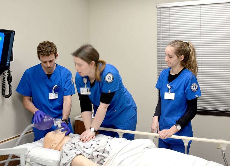 Marc Hayot/Herald-Leader John Brown University Nursing student Callie Gentry (right) observes fellow students Drew Knudtson administering oxygen and Hannah Kintzel performing chest compressions on a "patient" during a simulated Code Blue on March 1. JBU was one of three colleges to receive American Rescue Plan Act funds to enhance its nursing school.