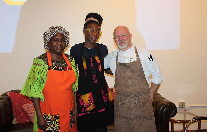 Margaret Wasonga and her daughter Emily Wasonga from Nairobi, Kenya, with Chef Marshall Shafkowitz introduce Feast with Friends guests to the evening's menu and traditions at the Canopy Northwest Arkansas inaugural event Feb. 19 at Brick & Mortar in Rogers. 
(NWA Democrat-Gazette/Carin Schoppmeyer)
