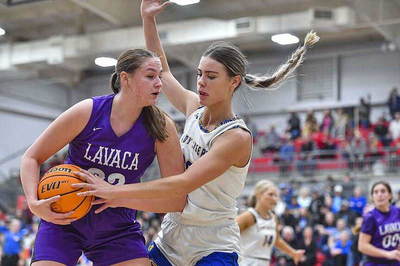 Lavaca forward Emerson Schaefer (22) looks to pass as Acorn forward Chanity Hall (20) defends, Wednesday, Feb. 28, 2024, during the second quarter in the opening round of the Class 2A Basketball State Tournament at Mansfield High School in Mansfield. Visit rivervalleydemocratgazette.com/photo for today's photo gallery.
(River Valley Democrat-Gazette/Hank Layton)