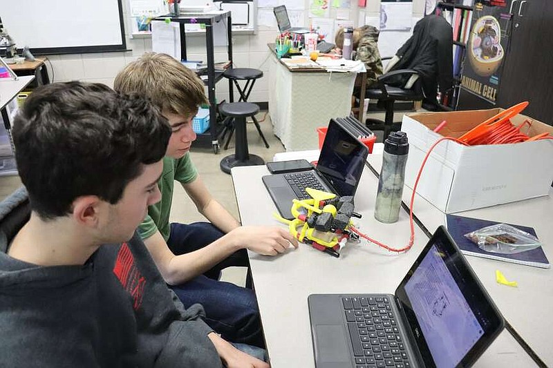 Gavin McGinley and Callen Shaw, students at Sheridan High School, show the progress they've made on designing their ROV from the ground up. (Special to The Commercial/University of Arkansas System Division of Agriculture)