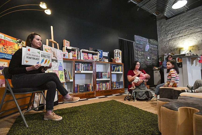 Bethany Meadows (left), owner of French with Bethany, reads a children's book in French to families, Saturday, Feb. 24, 2024, at a weekly story time event at Bookish: An Indie Shop for Folks Who Read in downtown Fort Smith. Meadows recently opened her French language business based in Fort Smith, where she offers one-on-one virtual French lessons. Visit rivervalleydemocratgazette.com/photo for today's photo gallery.
(River Valley Democrat-Gazette/Hank Layton)