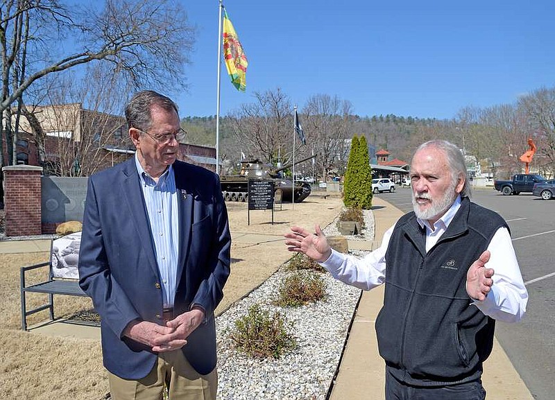 Garland County Veterans Memorial Committee President Tom Wilkins, right, discusses some of the vandalism done to the memorial and military park while Richard Green, the organization's treasurer, looks on. (The Sentinel-Record/Donald Cross)