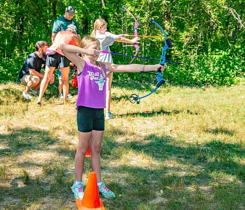 News Tribune file
In this July 2023 file photo, Megan Carlock, 11, tries archery for the first time at Runge Nature Center's Birthday Party. Those who want to try archery for the first time can learn at an upcoming March event at the Runge Center.
