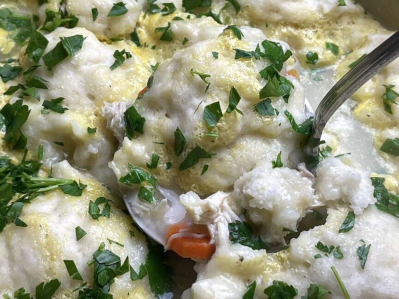 Kelly Brant/Arkansas Democrat-Gazette 
Mom's chicken and dumplings are big, puffy, pillowy mounds of edible heaven suspended in a flavorful broth flecked with bites of chicken and carrots.