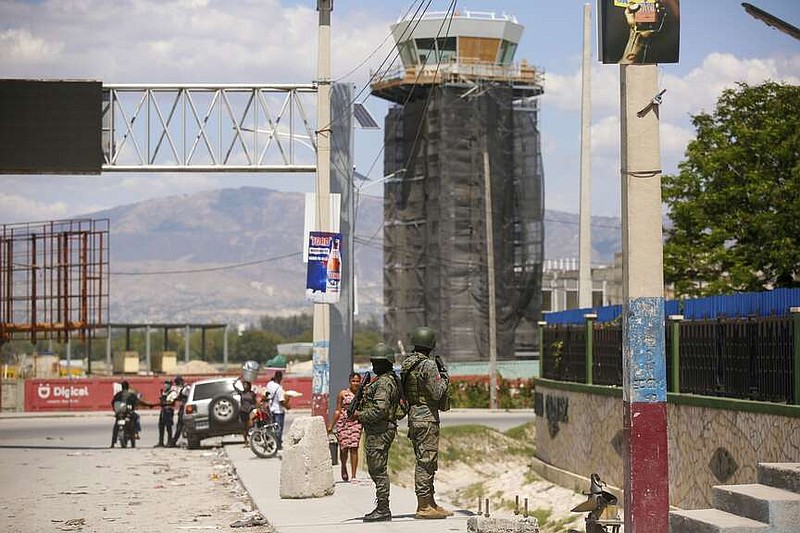 Soldiers guard the entrance of the international airport in Port-au-Prince, Haiti, Monday, March 4, 2024. Authorities ordered a 72-hour state of emergency starting Sunday night following violence in which armed gang members overran the two biggest prisons and freed thousands of inmates over the weekend. (AP Photo/Odelyn Joseph)