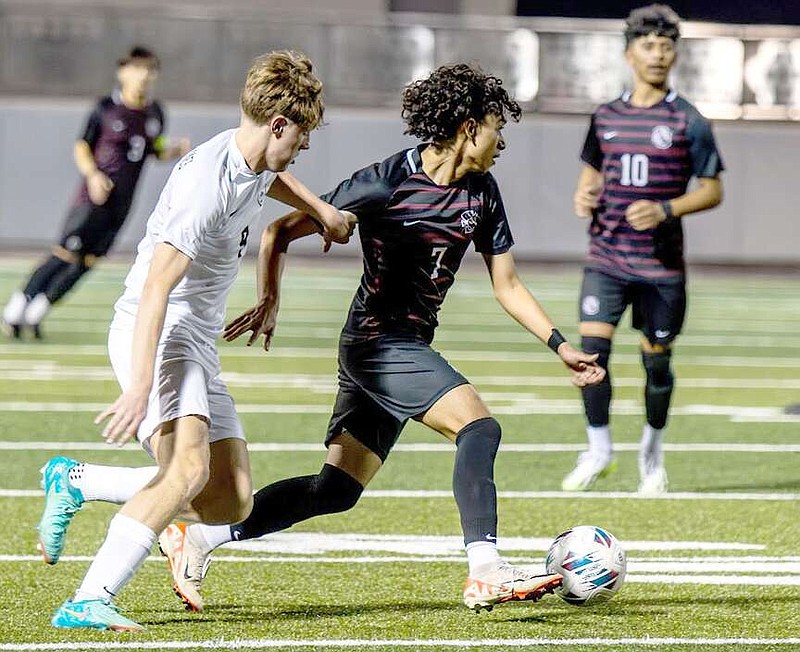 Photograph courtesy of Krystal Elmore Diego Palacios of Siloam Springs moves the ball against Bentonville West in a match played Feb. 26 at Panther Stadium.