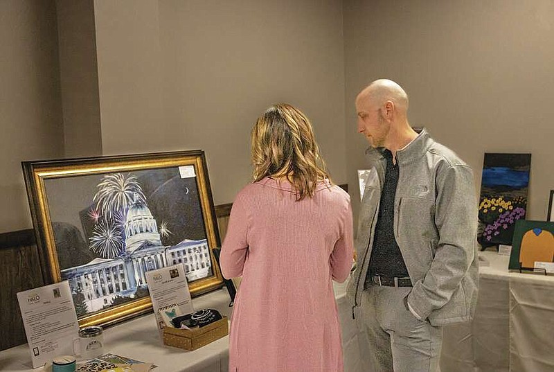 News Tribune file
 Brad and Brittany Schlup look at some of the art work available during the HALO Art Auction on March 2, 2023, at the Capitol Bluffs Event Center.