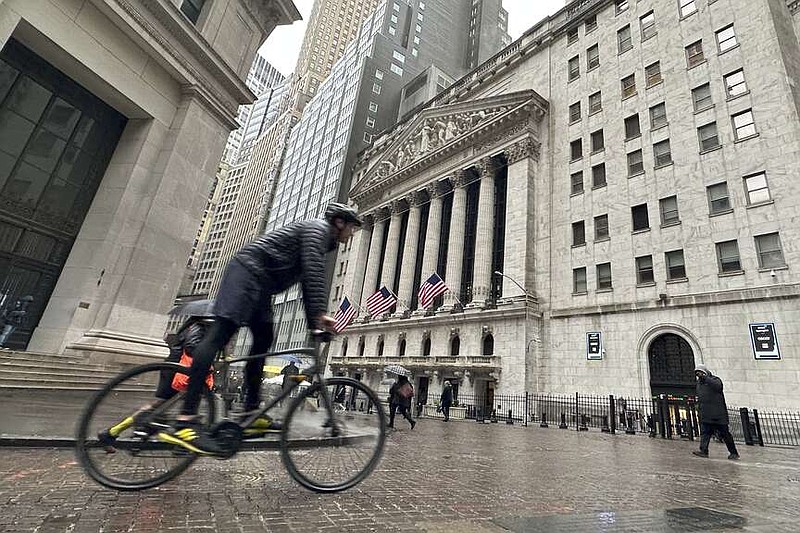 A bicyclist passes the New York Stock Exchange on Tuesday, March 5, 2024, in New York. Wall Street pointed modestly lower as more retailers post results from the holiday season and ahead of appearance by Federal Reserve Chair Jerome Powell before Congress later this week. (AP Photo/Peter Morgan)