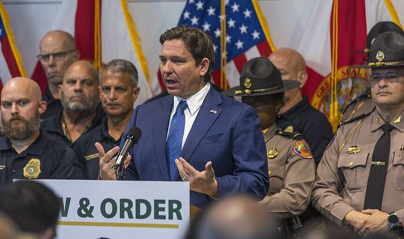 Gov. Ron DeSantis speaks during a news conference in Miami Beach, Fla., on Tuesday March  5, 2024.  After three consecutive years of spring break violence, Miami Beach officials are implementing monthlong security measures aimed at curbing the chaos, including parking restrictions for non-residents and closing sidewalk cafes on busy weekends.  (Pedro Portal/Miami Herald via AP)