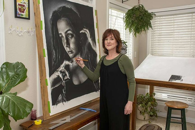 Crystal Jennings creates hyper-realistic charcoal drawings in the sunroom studio of her home. (Arkansas Democrat-Gazette/Cary Jenkins)