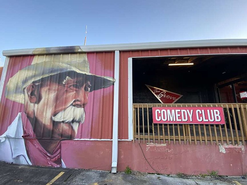 The late Dave Clark, "Uncle Dave," watches the entrance to The Grove Comedy Club in Lowell. As they club heads into its ninth year of operation this April, regional comedians are taking part in a Sunday Comedy Showdown, which will give them the chance to be a headliner at the club, not an easy feat for a newcomer. 
(NWA Democrat-Gazette/Monica Hooper)