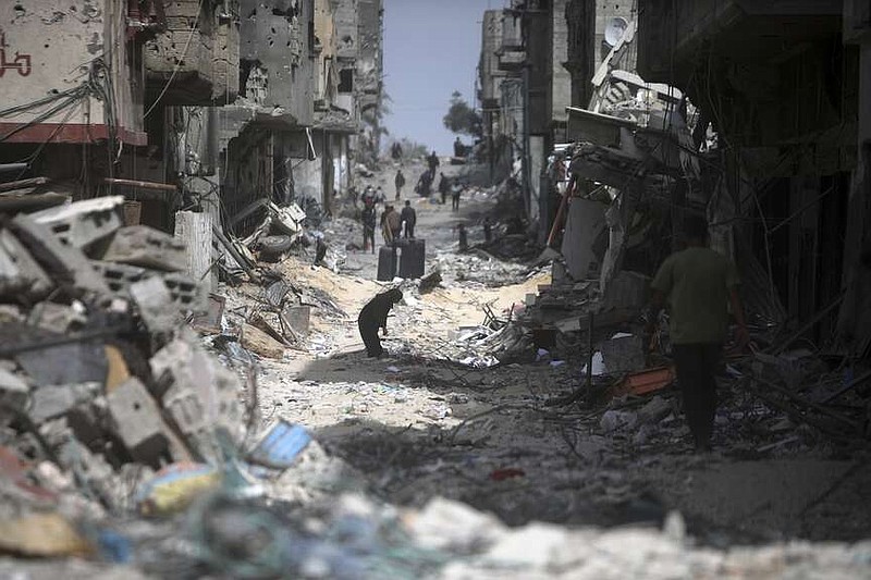 Palestinians visit their destroyed homes after Israeli forces left Khan Younis, Gaza Strip, Wednesday, March 6, 2024. (AP Photo/Mohammed Dahman)
