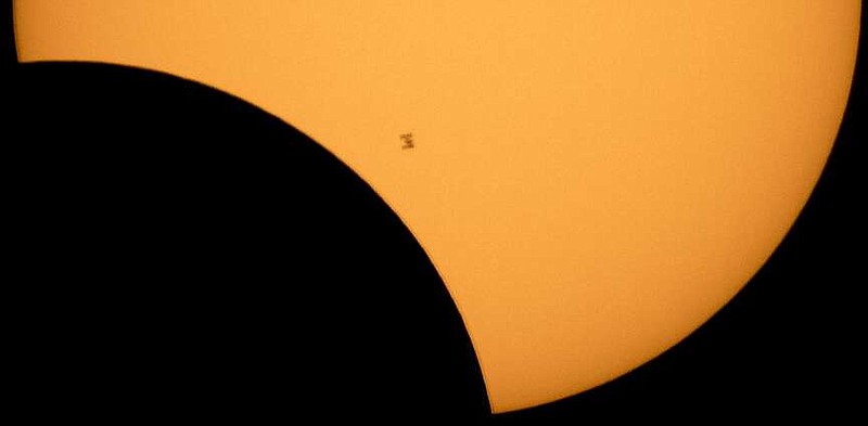 In this image made available by NASA, the International Space Station is silhouetted against the sun during a solar eclipse on Monday, Aug. 21, 2017, as seen from Ross Lake, Northern Cascades National Park in Washington state. (Bill Ingalls/NASA via AP/File)