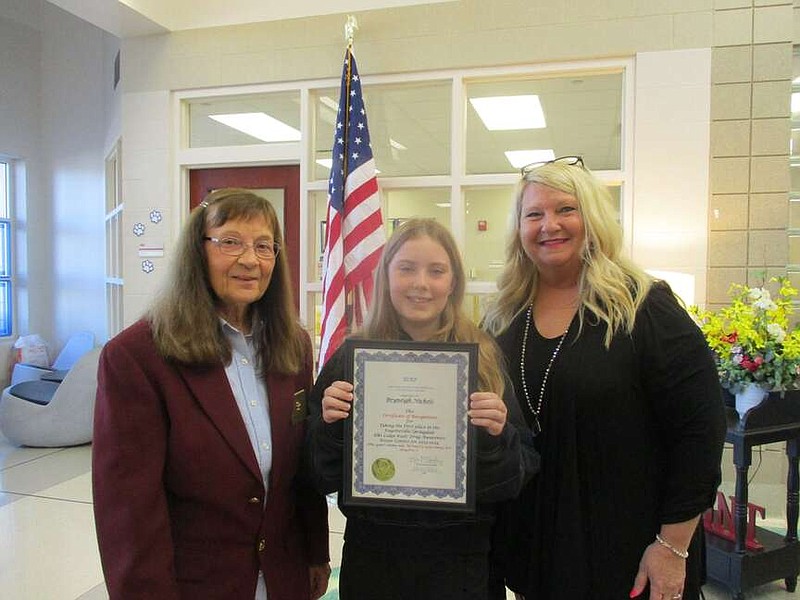 Bryneigh Nichols, a fifth grader from J.B. Hunt Elementary, won first place in the Fayetteville/Springdale Elks Lodge Drug Awareness Poster contest this year. The theme for the contest was "Be kind to your mind, live drug-free." She was presented with a certificate and a check for one hundred dollars by Kim McGaughey, Elk drug awareness chair, and Marge Guist, Elk Americanism chair. Nichols' poster went on to the State Drug Awareness Poster competition. Pictured from left are Guist, Nichols and McGaughey.

(Courtesy Photo)