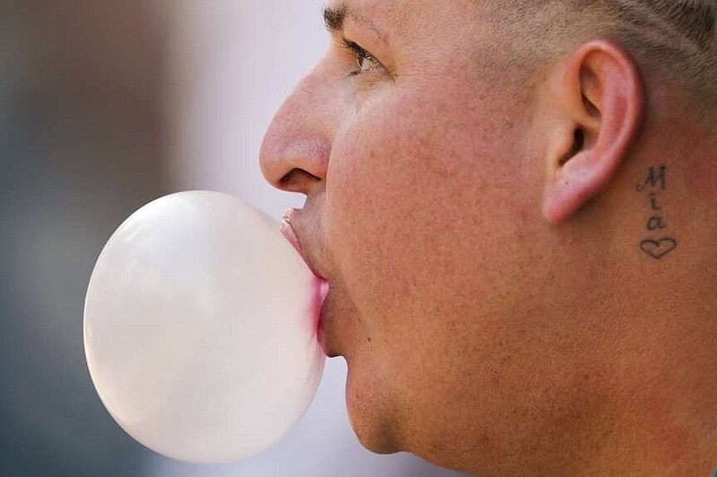 Seattle Mariners starting pitcher Jhonathan Díaz blows a bubble during the first inning of a spring training baseball game against the Cleveland Guardians on Feb. 25, 2024, in Peoria, Ariz. Gum maker Mars says its research shows half of gum consumers chew to relieve stress or help their focus. (AP Photo/Lindsey Wasson, File)