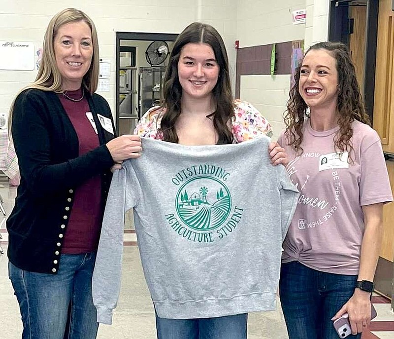 Submitted photo/Gentry School District
Madison Lenda (center) was recognized last week with the Farm Bureau Agriculture Student of the Month award. She has shown great leadership within the Gentry FFA chapter, been on multiple career development event teams, had active supervised agricultural experience and is currently interning at a local veterinarian's office. Laura Evans and Lindsi Miles presented the award for Farm Bureau.
